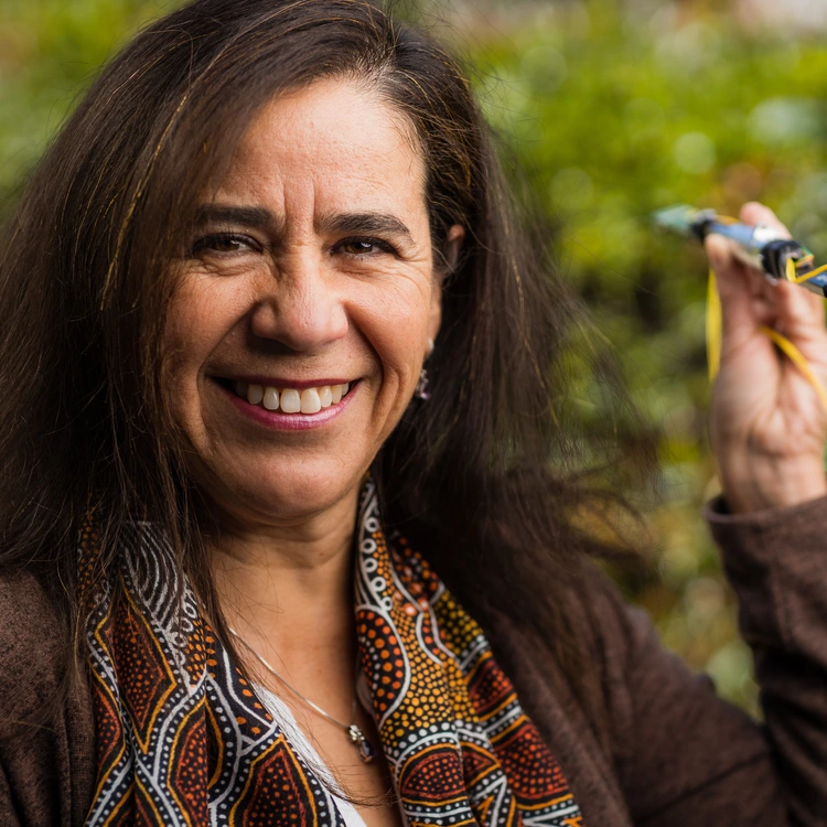 Solange Ramirez poses with an SDSS-V robot