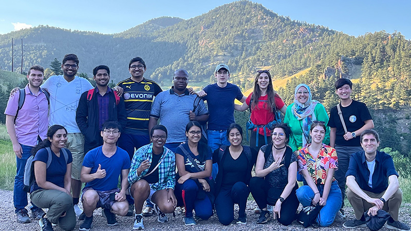 Group of students with green hills in the background on a sunny day