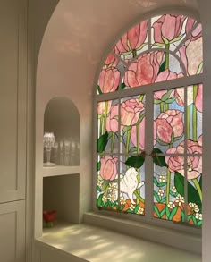 an arched window with pink flowers on it