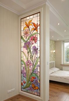a stained glass window in the corner of a room with a bed and dresser next to it