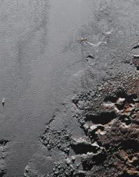 This enhanced color view from NASA's New Horizons spacecraft zooms in on the southeastern portion of Pluto's great ice plains, where at lower right the plains border rugged, dark highlands informally named Krun Macula.