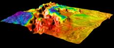 This perspective view of Venus, generated by computer from NASA's Magellan data and color-coded with emissivity, shows the boundary between the lowland plains and characteristic Venusian highland terrain in Ovda Region.