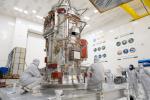 Engineers and technicians work on the towering main body of NASA's Europa Clipper spacecraft in the storied Spacecraft Assembly Facility at the agency's Jet Propulsion Laboratory.