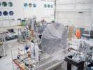 Engineers and technicians install Europa Clipper's high-gain antenna in the main clean room at JPL.