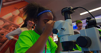 students observing a teacher with a starfish