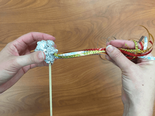 the foil is now a round shape over the end of the chopsticks with the ribbons sticking out the side