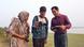 Shamim Hossain with two students in a field in Bangladesh