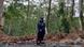 Susi Gustiana standing in a forest