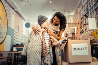 volunteer helping elderly at shelter