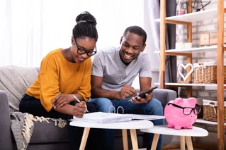 man and woman smiling over papers