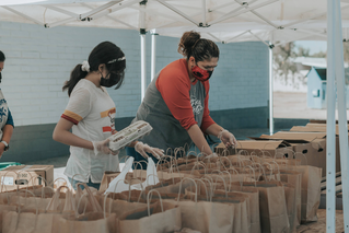 woman and girl sorting groceries