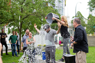 People in a park dumping ice on man