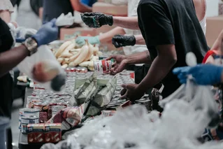 People distributing food to others