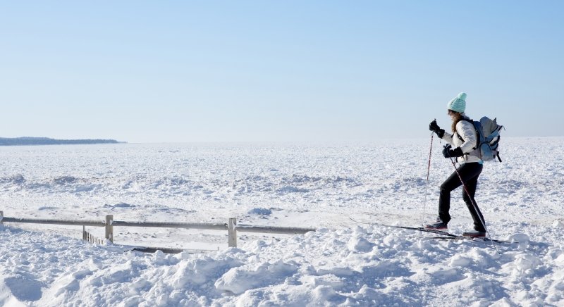 Person snowshoeing through a wide open space.