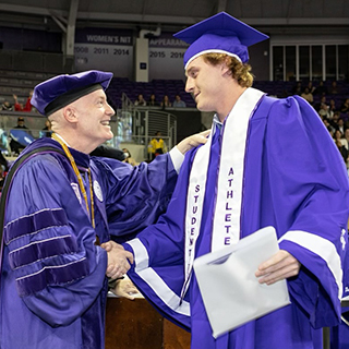 Max Duggan shaking hands with Chancellor Boschini at graduation