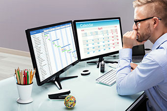 Schedule On Computer Screen. Employee Looking At Calendar