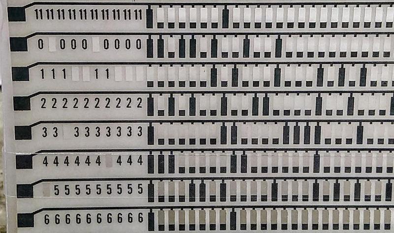 Detail of a CCROS sheet. It is programmed by punching holes in it with a keypunch. Detail of a CCROS sheet. It is programmed by punching holes in it with a keypunch.