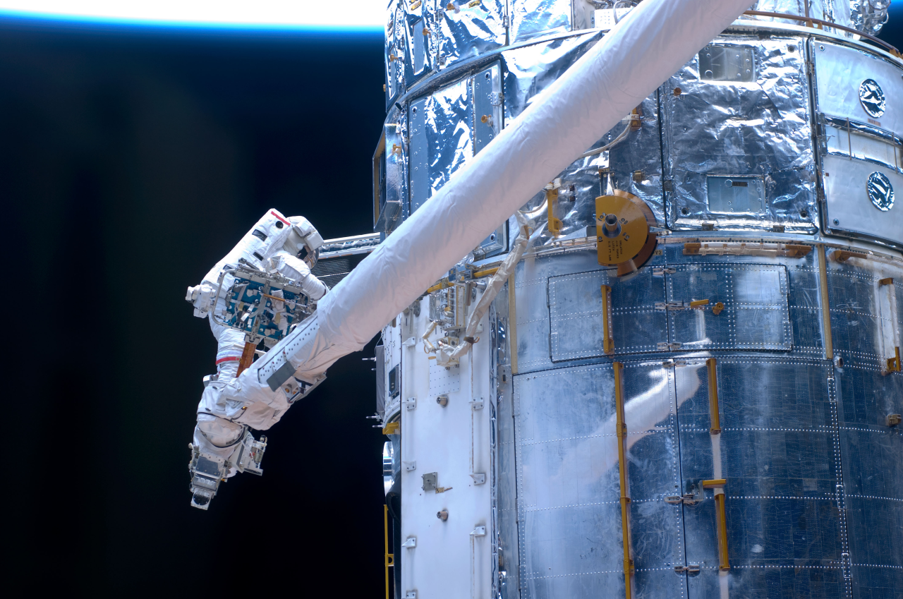 Astronaut John Grunsfeld works on repairs to the Hubble Space Telescope.