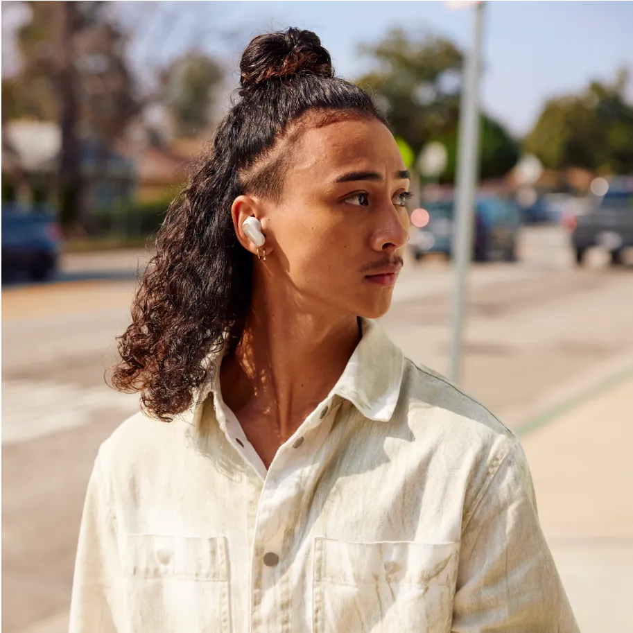 Young man wearing Bose QuietComfort Ultra Earbuds outside.