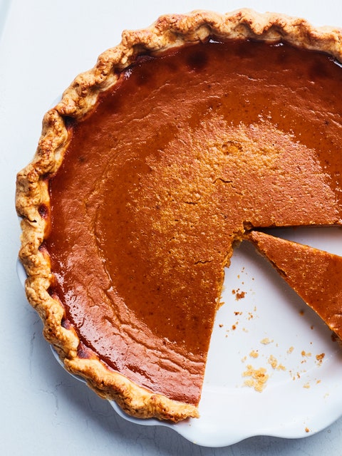 Best Pumpkin Pie Recipes for Thanksgiving 2021. Bourbon pumpkin pie with several slices taken out of the pie dish.