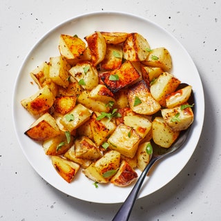 Cubed Greekstyle potatoes baked with oregano and lemon on a plate.