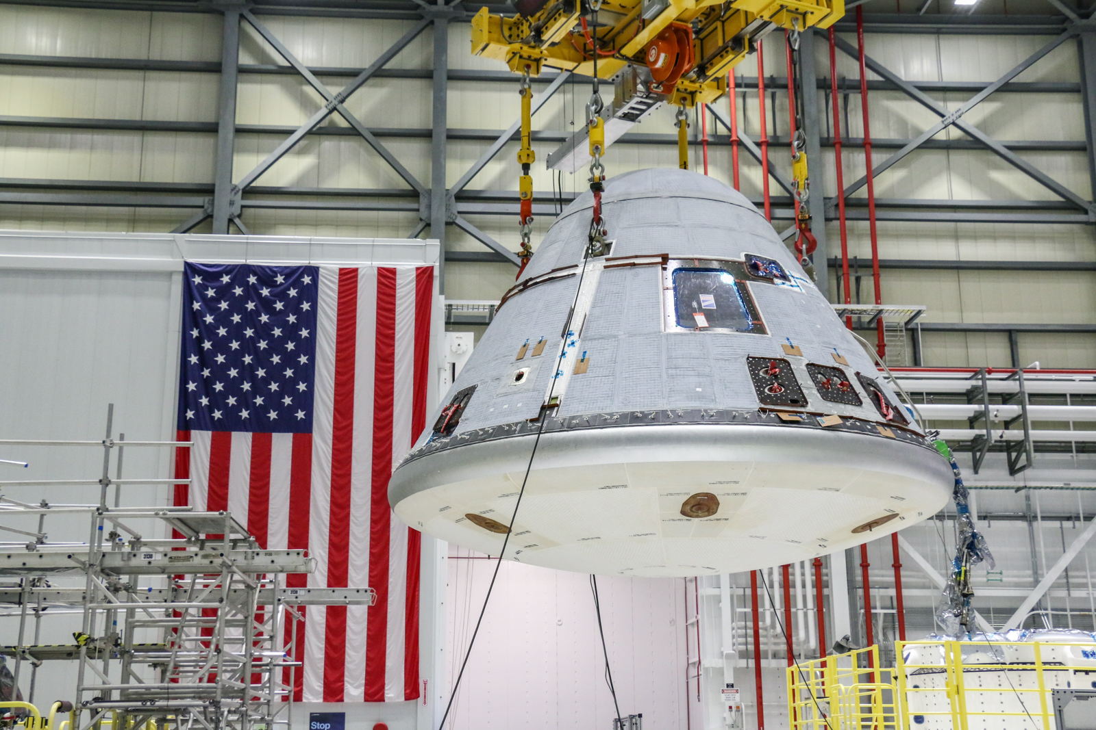 Boeing Starliner is lifted inside processing facility