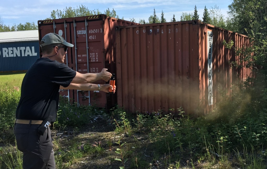 ABoVE staff scientist Peter Griffith, of NASA’s Goddard Space Flight Center, practices deploying bear spray. "Wait until it’s closer than you’re comfortable with," advises Sarah Sackett, who provides safety training for scientists heading out into the field. Credit: NASA/Kate Ramsayer