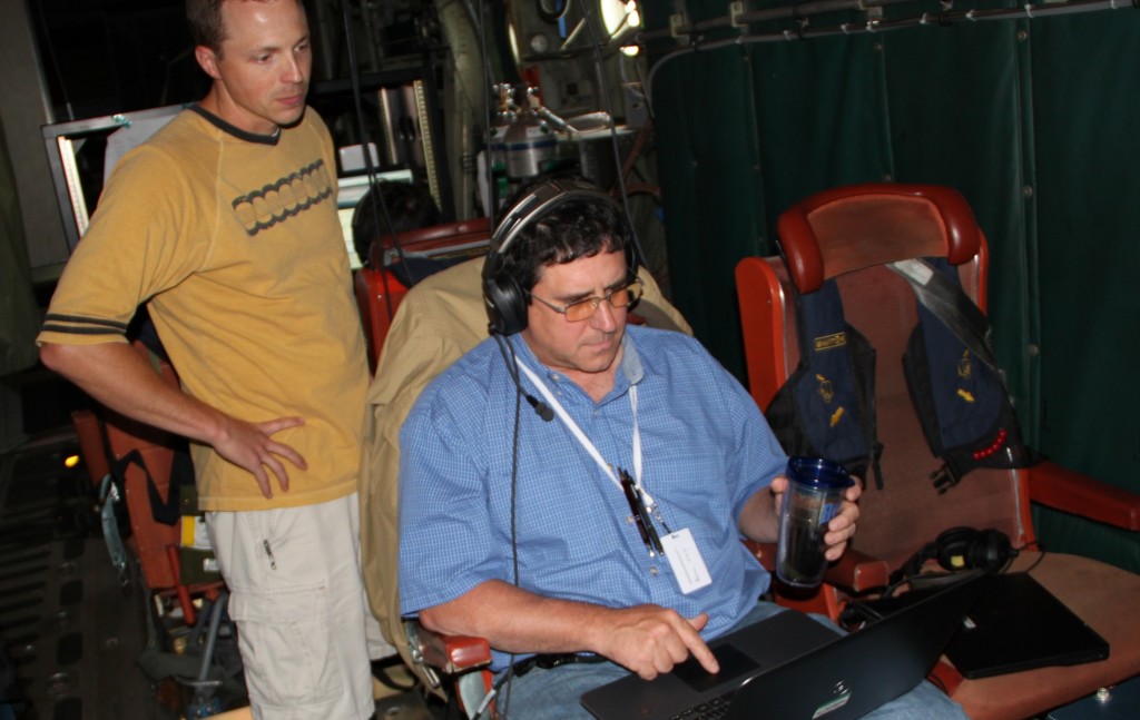 Aboard the C-130H, Nathan Blume (standing) and Jeremy Dobler monitor data from an instrument that uses laser light to measure atmospheric carbon dioxide. Credit: NASA/Sam McDonald