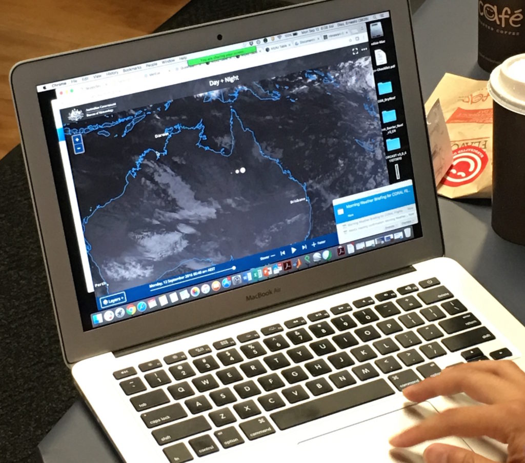 Ernesto Diaz looks to weather forecasts from the Australian Bureau of Meteorology to determine if a CORAL flight will happen on any given day. Credit: NASA/Alan Buis