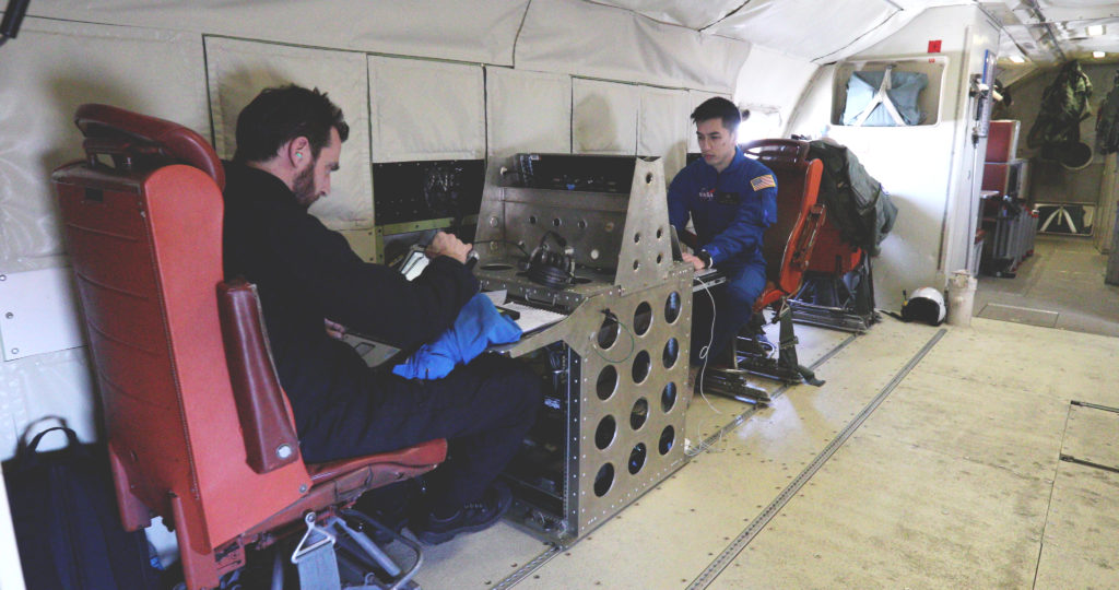 Scientists Alex Coccia (left) and Albert Wu during a SnowEx science flight over Colorado. Credit: NASA/Joy Ng