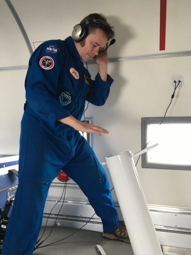 Josh Willis after releasing an ocean probe down the white tube, where it drops from the plane into the ocean. Credit NASA/JPL-Caltech