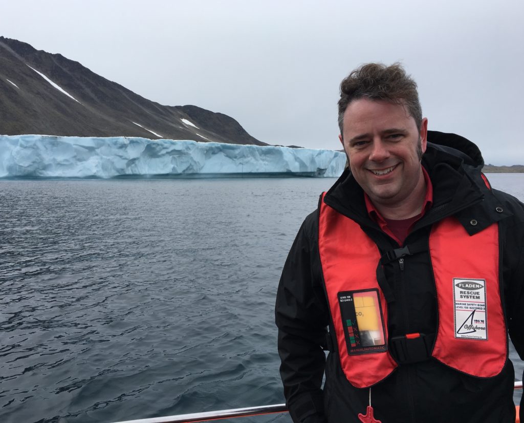 Josh Willis, OMG’s principal investigator, on approachby boat to Apusiaajik glacier in Greenland. Credit NASA/JPL-Caltech