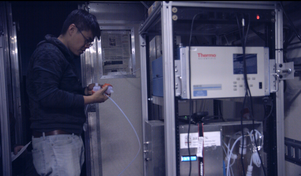 Jiajue prepares sample bottles for his instrument inside the Mobile Lab. July 24, 2019. Credit: NASA