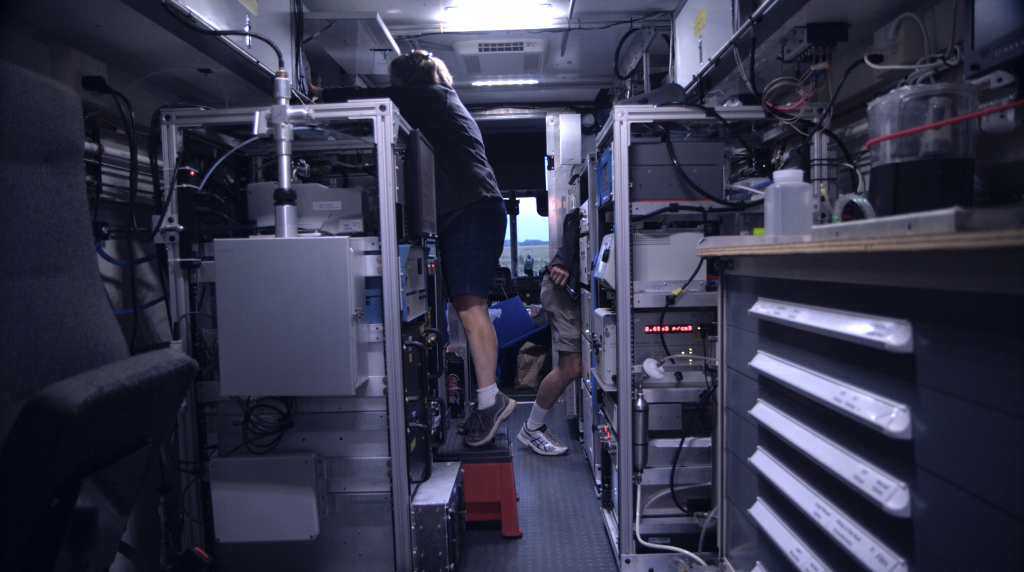 Kathleen sets up her instrument that will filter exterior air and capture airborne particles on filters. She'll take the filters, frozen to preserve them, back to her lab at the end of the campaign for analysis. July 24, 2019. Credit: NASA