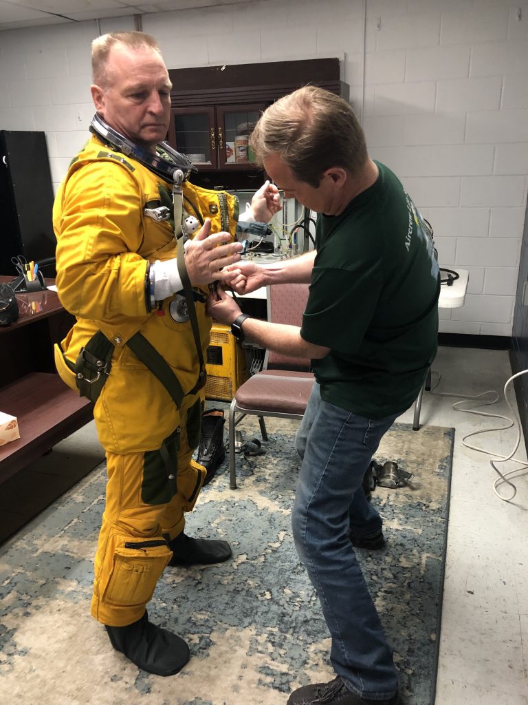 ER-2 Pilot Cory Bartholomew being helped into his full pressure suit by Joey Barr from the Life Support Team. Credit: NASA/Katie Stern