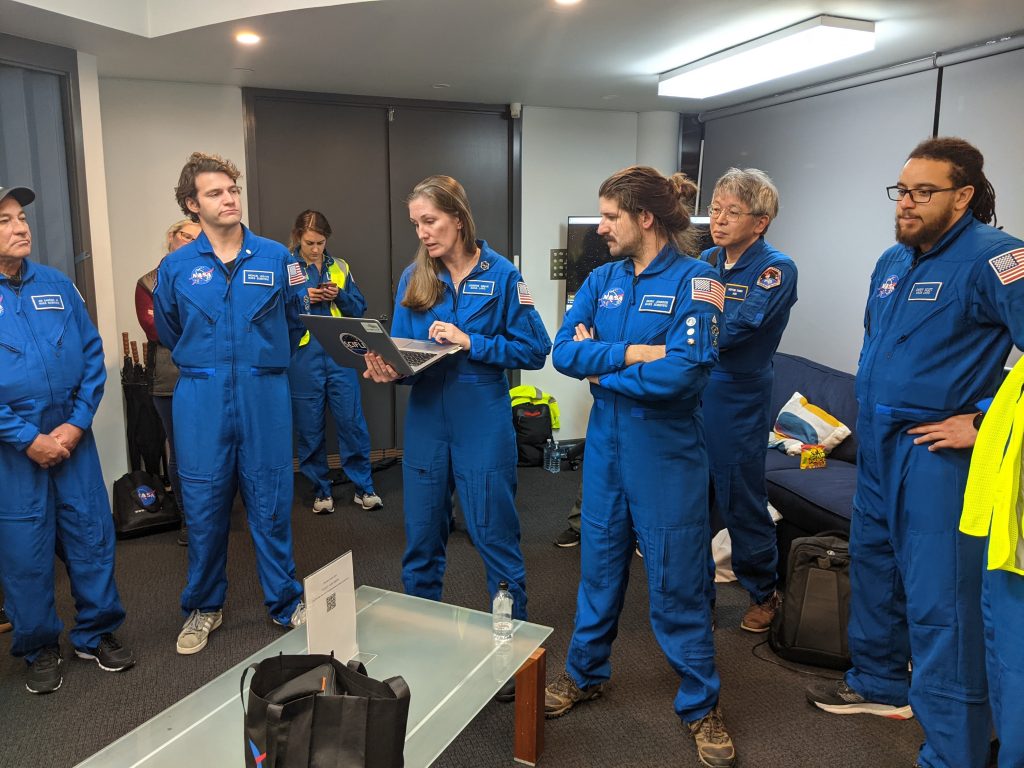 The team conducts a final pre-flight briefing just prior to the observation flight. From left to right: Joe Sanchez, Jr., Caitlin Murphy, Michael Legato, Katelyn Gunderson, Jennifer Inman, Brent Johnson, Hideyuki Tanno, Carey Scott, Jr. Credit: NASA