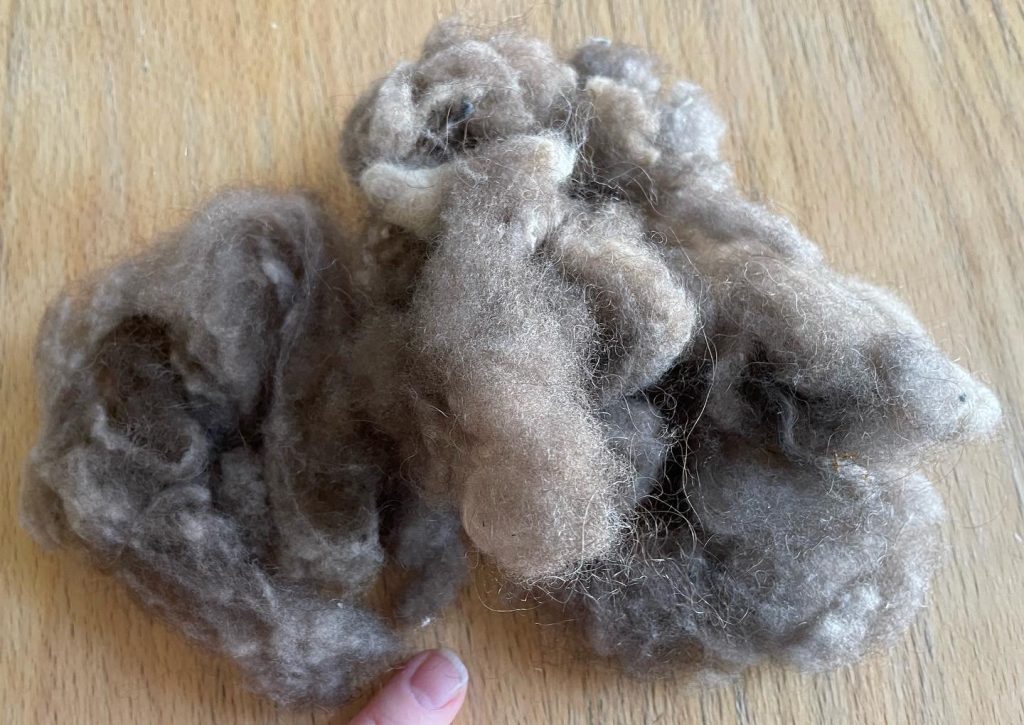 A clump of musk ox wool piled up on a table.