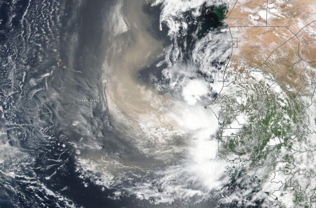 Satellite image of dust over the Atlantic Ocean off the northern coast of Africa. Borders are outlined in black. The dust is mostly between the mainland coast and Cabo Verde.