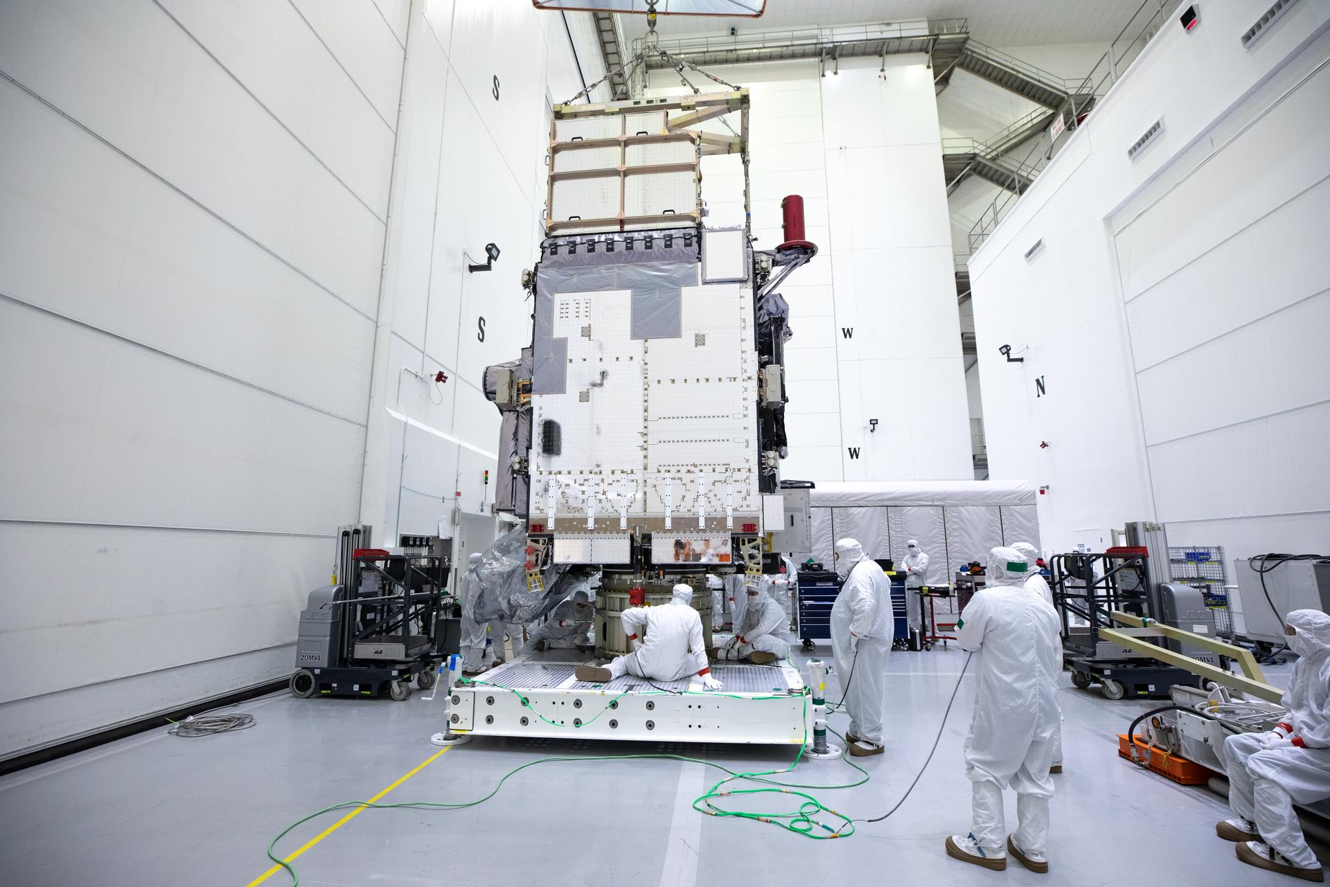 Technicians monitor movement and guide NOAA’s Geostationary Operation Environmental Satellite-U (GOES-U) as a crane hoists it on to a spacecraft dolly in a high bay at the Astrotech Space Operations Facility near the agency’s Kennedy Space Center in Florida. 