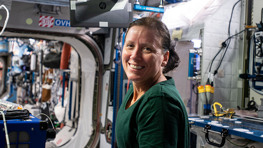 Expedition 64 Flight Engineer Shannon Walker of NASA installs an airborne particulate monitor in the Tranquility module.