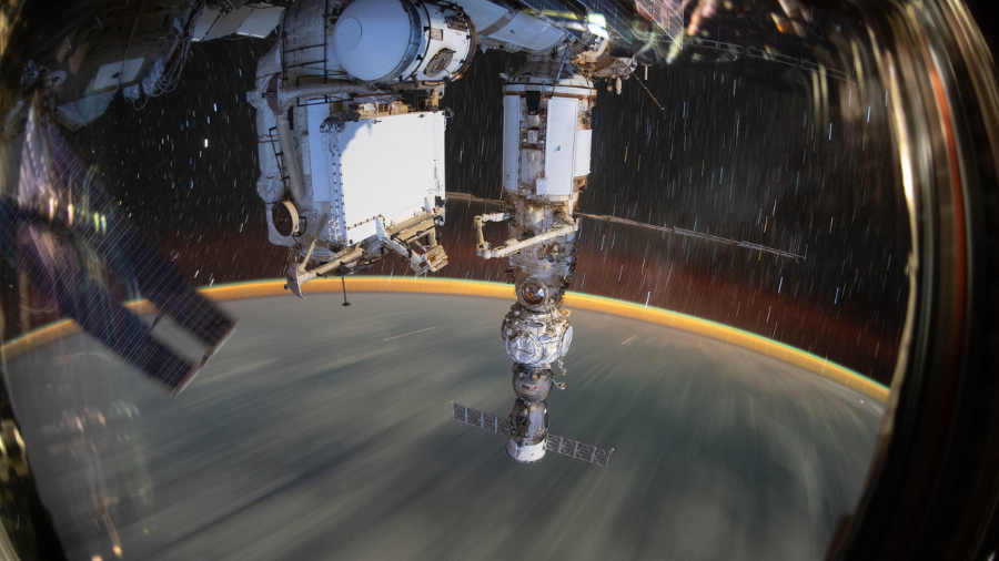 This long-duration photograph shows the Earth 259 miles below a soaring International Space Station on Sept. 19, 2022. In the foreground, is the Soyuz MS-21 crew ship docked to the Prichal docking module which is itself attached to the Nauka multipurpose laboratory module.