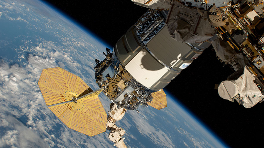 Still in the grips of the Canadarm2 robotic arm, the Northrop Grumman Cygnus space freighter is pictured attached to the Unity module's Earth-facing port above the Pacific Ocean.