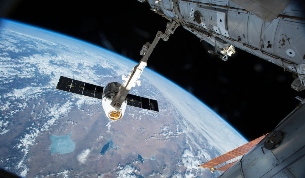 The Canadarm 2 reaches out to grapple a SpaceX Dragon cargo spacecraft and prepare it to be pulled into its port on the International Space Station. Dragon was installed on the Harmony module where remained for the next five weeks. Photo credit: NASA