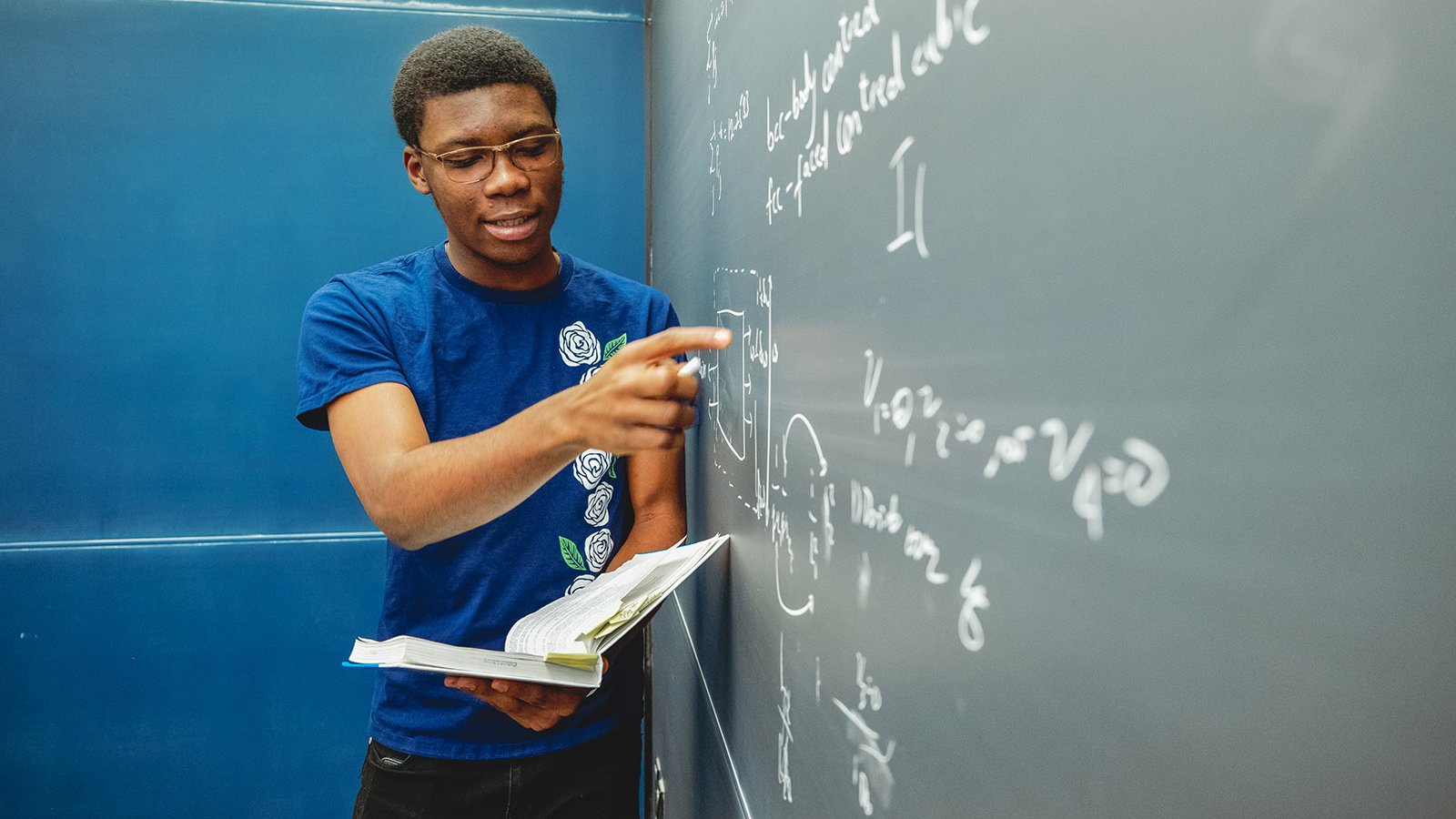 A person writing on a blackboard