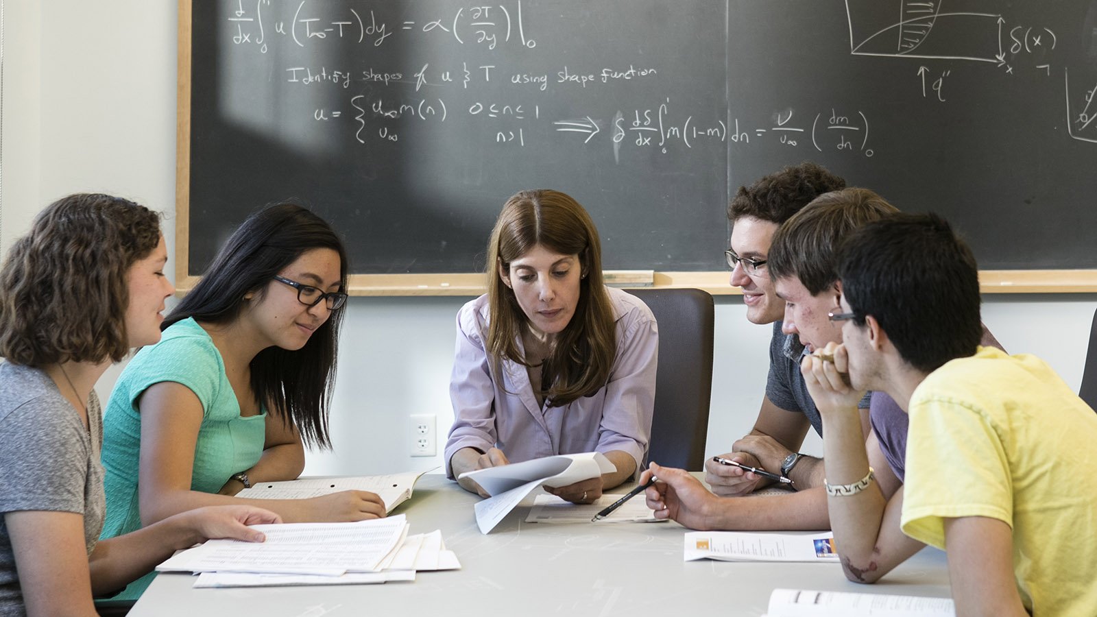 A photo of a group of people in a classroom