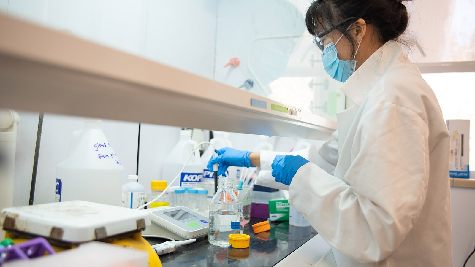 A photo of a person working in a biochemistry lab