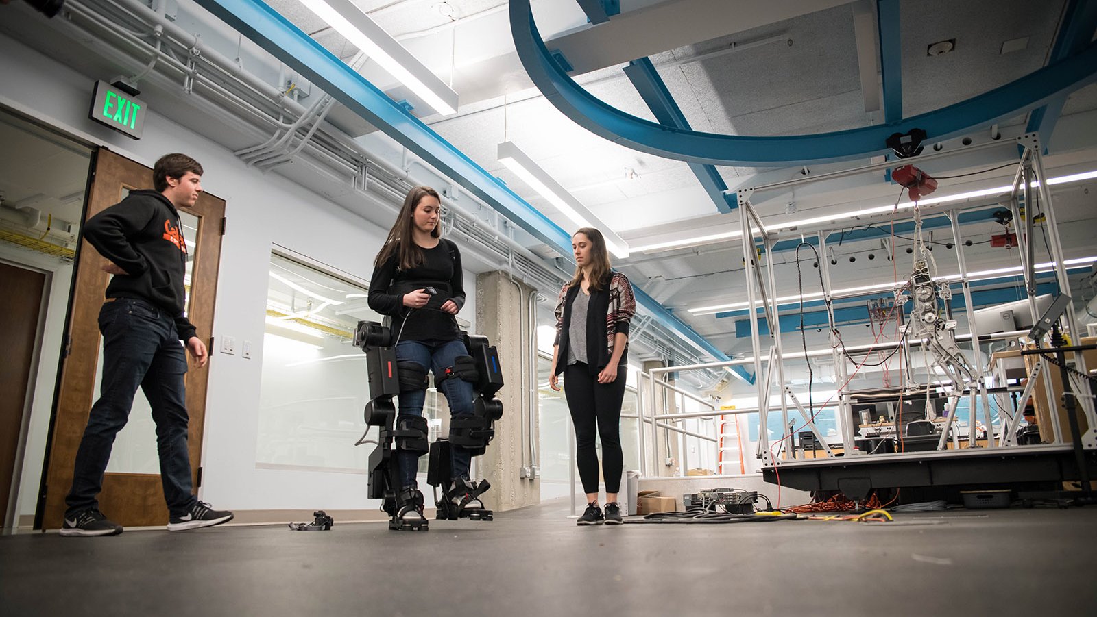 A photo of three people in an engineering lab