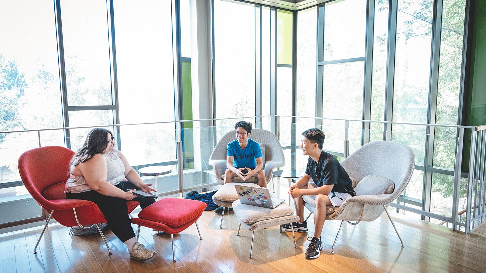 A photo of three students sitting in the Annenberg lobby