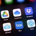 An iPhone screen displaying icons for file sharing apps Google Drive, OneDrive, Dropbox, pCloud, Box, and Sync.