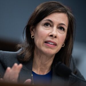 FCC Chairwoman Jessica Rosenworcel sits in front of a microphone while testifying during a Congressional hearing.